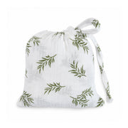 Swaddle Blanket - Wild Olive presented in a matching white muslin drawstring bag with olive-green botanical branches and fabric ties