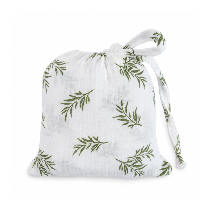Swaddle Blanket - Wild Olive presented in a matching white muslin drawstring bag with olive-green botanical branches and fabric ties