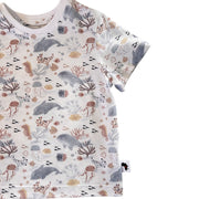 A short-sleeve child's t-shirt with an all-over underwater-themed print featuring whales, dolphins, jellyfish, seahorses, and coral in muted gray, terracotta, and beige tones.