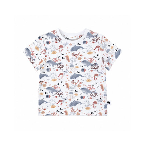 A short-sleeve baby and toddler t-shirt with an all-over underwater-themed print featuring dolphins, sea anemones, starfish, and sponges in muted gray, brown, and beige tones on a white background.