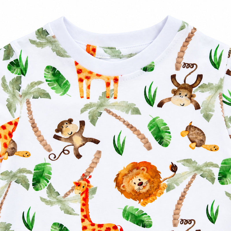 Close-up of the Tee Shirt - Simba Watercolour showing the white ribbed crew neckline, neat topstitching and detailed lion, giraffe, monkey, turtle and tropical-leaf print.