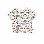 Front view of white Tee Shirt – Two By Two with short sleeves, a white ribbed neckline and an all-over giraffe, elephant, flamingo, zebra, leopard and palm-tree print
