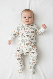 Baby wearing Footy Romper - Two By Two white cotton baby sleepsuit with elephants, giraffes, zebras, leopards, flamingos and palm trees.