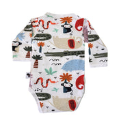 Back view of a white long-sleeve baby wrap onesie bodysuit with a colorful cartoon animal and nature print, featuring monkeys, crocodiles, snakes, flowers, and leaves.