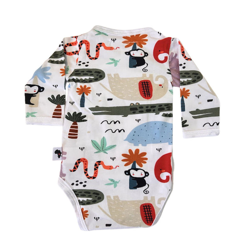 Back view of a white long-sleeve baby wrap onesie bodysuit with a colorful cartoon animal and nature print, featuring monkeys, crocodiles, snakes, flowers, and leaves.