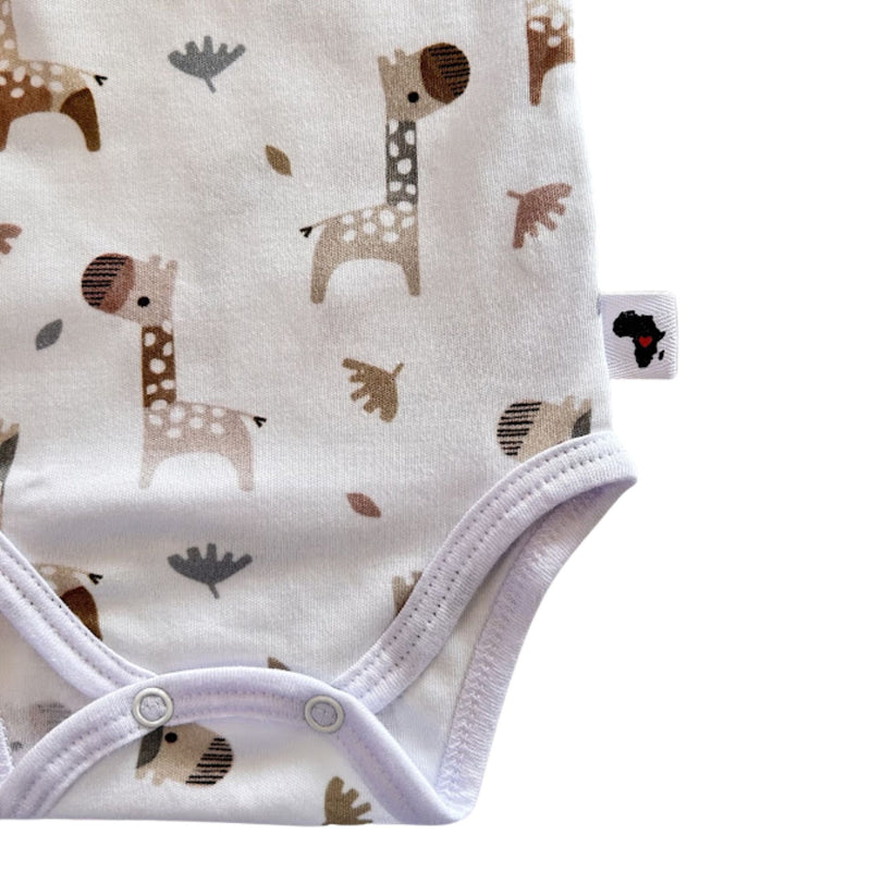 Bottom close-up of Wrap Onesie - Short Sleeve - Kameelperd showing two crotch press studs, bound leg openings and Baba Fishees Africa side label