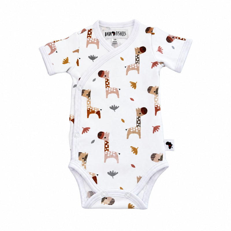 A baby short-sleeve wrap bodysuit with an all-over giraffe print on a white background, featuring a white trim and snap closures.