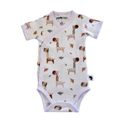 A baby short-sleeve wrap bodysuit with an all-over giraffe print on a white background, featuring a white trim and snap closures.