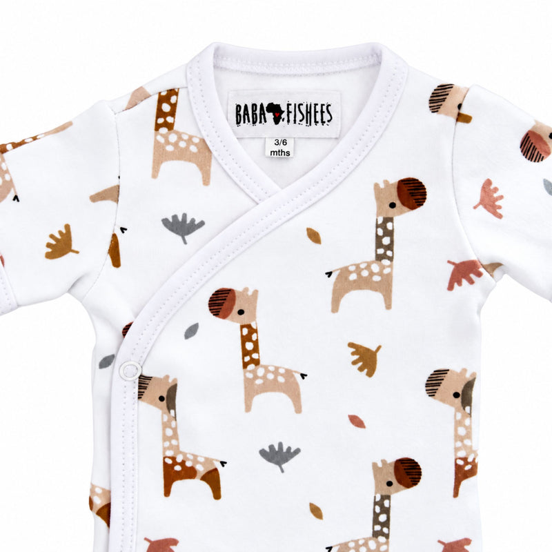 Neckline close-up of Wrap Onesie - Short Sleeve - Kameelperd showing the bound crossover neck, Baba Fishees label and upper press-stud fastening