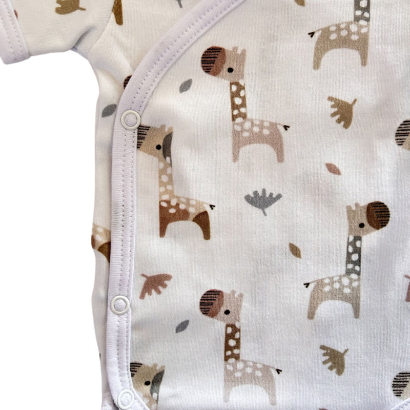 Side close-up of Wrap Onesie - Short Sleeve - Kameelperd showing the row of three press studs, neat white binding and detailed giraffe illustrations