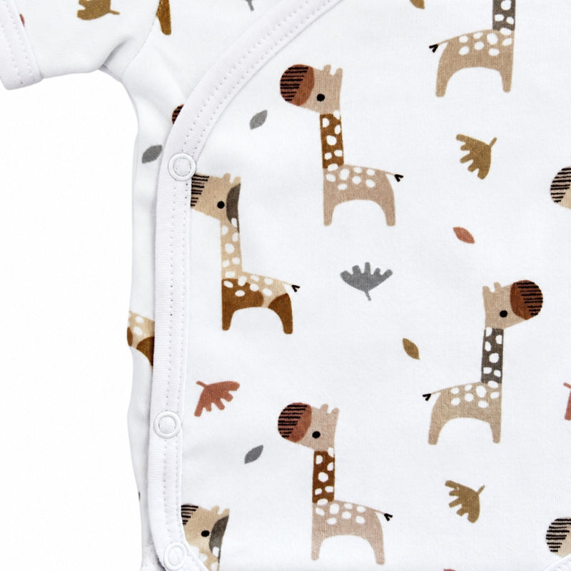 Side close-up of Wrap Onesie - Short Sleeve - Kameelperd showing the row of three press studs, neat white binding and detailed giraffe illustrations