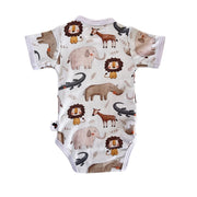 A short-sleeve baby bodysuit with an all-over safari animal print on a white background. The print features watercolor-style illustrations of lions, elephants, rhinos, giraffes, crocodiles, and an okapi in earthy brown, gray, and black tones.