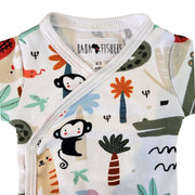 A close-up of a baby wrap onesie with a colorful cartoon animal and plant print on a white background. The brand label 'BABA FISHEES' is visible inside the collar.