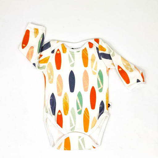 A soft, high-quality long sleeve cotton classic onesie with different coloured longboards.